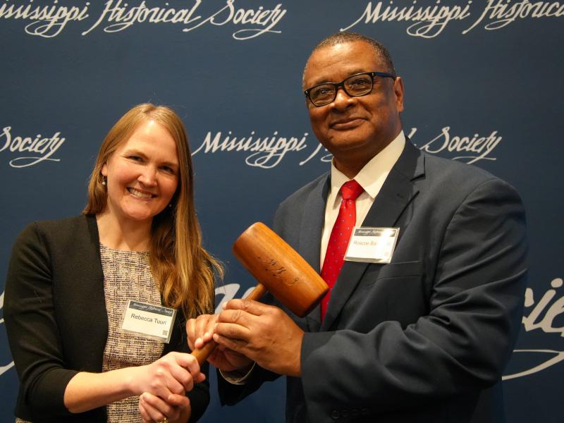 Pictured: Rebecca Tuurri completes her term as president of the Mississippi Historical Society and hands the gavel to Roscoe Barnes III during the group's 2025 Annual Meeting.